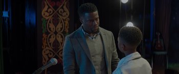 Movie still from “Me Time” (2022), directed by John Hamburg – A man in a suit talking to a young man; Medium shot, Over the shoulder angle