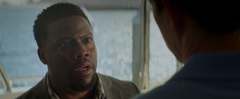 Movie still from “Me Time” (2022), directed by John Hamburg – A person sitting in front of a window; Close Up shot, Over the shoulder angle