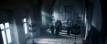 Movie still from “Medieval” (2022), directed by Petr Jákl – A group of people gathered inside a church; Extreme Wide shot, High angle