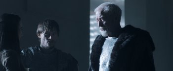 Movie still from “Medieval” (2022), directed by Petr Jákl – A man in a fur coat standing next to another man; Medium shot, Over the shoulder angle