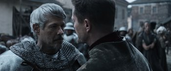Movie still from “Medieval” (2022), directed by Petr Jákl – Two men in medieval garb are facing each other; Close Up shot, Over the shoulder angle