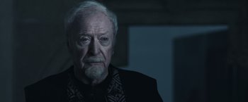 Movie still from “Medieval” (2022), directed by Petr Jákl – An old man with a beard and a mustache; Close Up shot, Over the shoulder angle