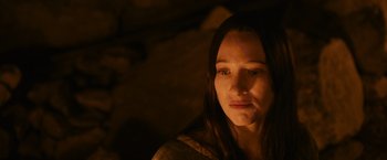 Movie still from “Medieval” (2022), directed by Petr Jákl – A young woman with long dark brown hair stares at the camera; Close Up shot, High angle