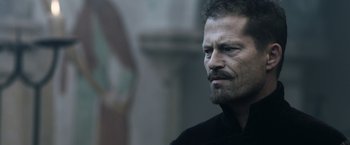 Movie still from “Medieval” (2022), directed by Petr Jákl – A person with a beard; Close Up shot, Over the shoulder angle