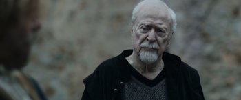 Movie still from “Medieval” (2022), directed by Petr Jákl – An older man with a beard and mustache; Close Up shot, Low angle