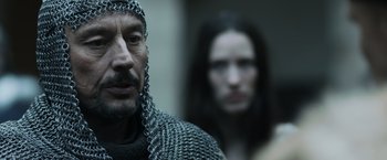 Movie still from “Medieval” (2022), directed by Petr Jákl – A man in chain mail and a woman in chain mail; Close Up shot, Over the shoulder angle