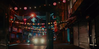 Movie still from “Meet Cute” (2022), directed by Alex Lehmann – A car driving down a street at night; Extreme Wide shot, High angle
