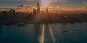 Movie still from “Meet Cute” (2022), directed by Alex Lehmann – The sun is setting over a large city; Extreme Wide shot, High angle