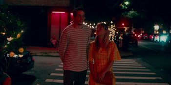 Movie still from “Meet Cute” (2022), directed by Alex Lehmann – A man and a woman standing on the side of a road; Medium shot, Low angle