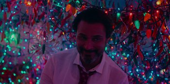 Movie still from “Meet Cute” (2022), directed by Alex Lehmann – A person wearing a shirt and tie; Close Up shot, Low angle