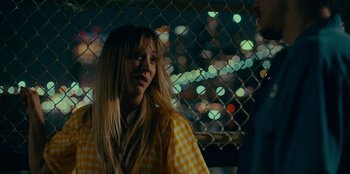 Movie still from “Meet Cute” (2022), directed by Alex Lehmann – A woman standing next to a man on a city street at night; Close Up shot, Over the shoulder angle