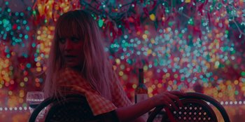 Movie still from “Meet Cute” (2022), directed by Alex Lehmann – A woman sitting in a car holding a steering wheel; Medium shot, High angle