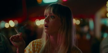 Movie still from “Meet Cute” (2022), directed by Alex Lehmann – A woman with long blonde hair looking up at the sky; Close Up shot, Low angle