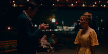 Movie still from “Meet Cute” (2022), directed by Alex Lehmann – A man and a woman talking to each other in a park; Medium shot, Over the shoulder angle
