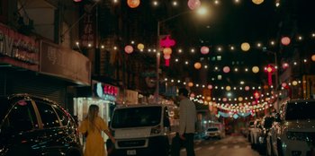Movie still from “Meet Cute” (2022), directed by Alex Lehmann – Two people walking down a street at night; Extreme Wide shot, Over the shoulder angle