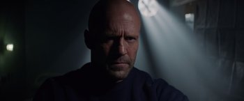 Movie still from “Meg 2: The Trench” (2023), directed by Ben Wheatley – A man with a bald head is looking at the camera; Close Up shot, Low angle