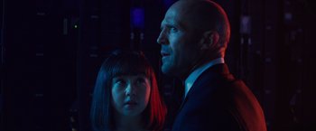 Movie still from “Meg 2: The Trench” (2023), directed by Ben Wheatley – A man and a woman standing next to each other in a dark room; Close Up shot, Low angle