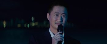 Movie still from “Meg 2: The Trench” (2023), directed by Ben Wheatley – A man holding a microphone up to his face; Close Up shot, Over the shoulder angle