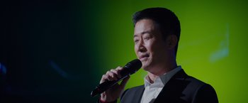 Movie still from “Meg 2: The Trench” (2023), directed by Ben Wheatley – A man holding a microphone up to his mouth; Close Up shot, Low angle