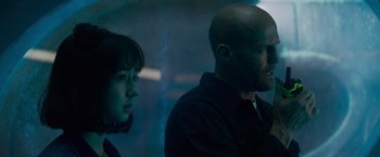 Movie still from “Meg 2: The Trench” (2023), directed by Ben Wheatley – A man and a woman standing next to each other; Close Up shot, Low angle