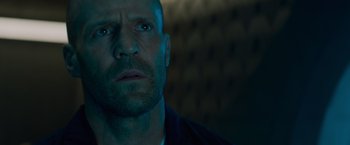 Movie still from “Meg 2: The Trench” (2023), directed by Ben Wheatley – A person wearing a jacket; Close Up shot, Low angle