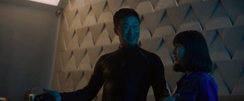 Movie still from “Meg 2: The Trench” (2023), directed by Ben Wheatley – A man in a black shirt is smiling for the camera; Medium shot, Low angle