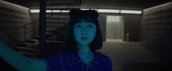 Movie still from “Meg 2: The Trench” (2023), directed by Ben Wheatley – A young woman wearing a blue shirt and black hair; Close Up shot, Low angle