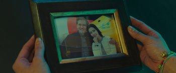 Movie still from “Meg 2: The Trench” (2023), directed by Ben Wheatley – A picture of a man and a woman in a picture frame; Extreme Close Up shot, Low angle