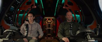 Movie still from “Meg 2: The Trench” (2023), directed by Ben Wheatley – A man and a woman sitting in a space ship; Medium shot, Low angle