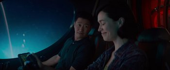 Movie still from “Meg 2: The Trench” (2023), directed by Ben Wheatley – A man and a woman sitting next to each other in a car; Medium shot, Over the shoulder angle