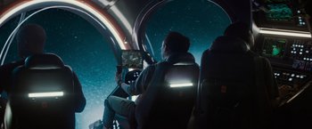 Movie still from “Meg 2: The Trench” (2023), directed by Ben Wheatley – A man sitting in a car holding a remote control; Wide shot, High angle