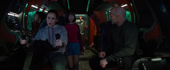 Movie still from “Meg 2: The Trench” (2023), directed by Ben Wheatley – A group of people sitting in a space ship; Medium shot, High angle