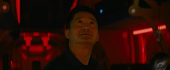 Movie still from “Meg 2: The Trench” (2023), directed by Ben Wheatley – A person wearing a black shirt; Close Up shot, Low angle