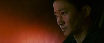 Movie still from “Meg 2: The Trench” (2023), directed by Ben Wheatley – A man's face in a dark room; Close Up shot, Low angle