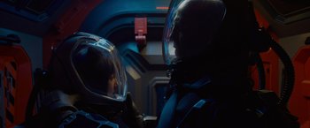 Movie still from “Meg 2: The Trench” (2023), directed by Ben Wheatley – A man and a woman in a space suit; Medium shot, Over the shoulder angle