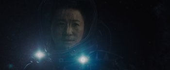 Movie still from “Meg 2: The Trench” (2023), directed by Ben Wheatley – A woman in a space suit with a light on her head; Close Up shot, Low angle