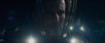 Movie still from “Meg 2: The Trench” (2023), directed by Ben Wheatley – A person wearing a helmet; Close Up shot, Over the shoulder angle