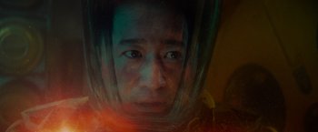 Movie still from “Meg 2: The Trench” (2023), directed by Ben Wheatley – A man wearing a space suit and a helmet; Close Up shot, High angle