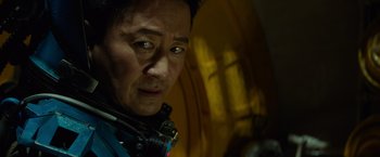 Movie still from “Meg 2: The Trench” (2023), directed by Ben Wheatley – A man's face in front of a window; Close Up shot, Low angle