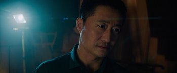 Movie still from “Meg 2: The Trench” (2023), directed by Ben Wheatley – A person wearing a black shirt; Close Up shot, Low angle