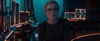 Movie still from “Meg 2: The Trench” (2023), directed by Ben Wheatley – A woman wearing glasses sitting in front of a computer screen; Close Up shot, Over the shoulder angle