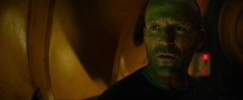 Movie still from “Meg 2: The Trench” (2023), directed by Ben Wheatley – A person's face in a dark room; Close Up shot, Low angle