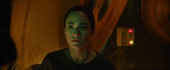 Movie still from “Meg 2: The Trench” (2023), directed by Ben Wheatley – A person wearing a black shirt; Close Up shot, Low angle