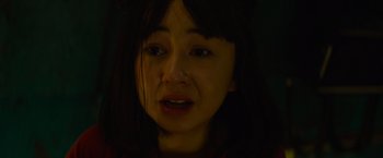 Movie still from “Meg 2: The Trench” (2023), directed by Ben Wheatley – A young woman crying in the dark with her eyes closed; Close Up shot, High angle