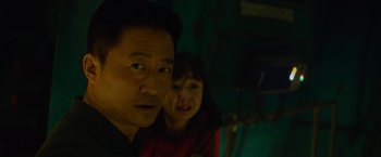 Movie still from “Meg 2: The Trench” (2023), directed by Ben Wheatley – A man and a woman in a dark room; Close Up shot, Low angle