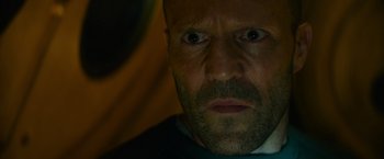 Movie still from “Meg 2: The Trench” (2023), directed by Ben Wheatley – A person with a beard; Close Up shot, Low angle