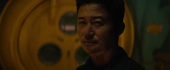 Movie still from “Meg 2: The Trench” (2023), directed by Ben Wheatley – A person wearing a black shirt; Close Up shot, Low angle