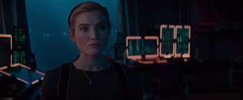 Movie still from “Meg 2: The Trench” (2023), directed by Ben Wheatley – A woman in a dark room looking at the camera; Close Up shot, Over the shoulder angle