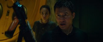 Movie still from “Meg 2: The Trench” (2023), directed by Ben Wheatley – A man and a woman standing next to each other; Close Up shot, Low angle