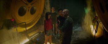 Movie still from “Meg 2: The Trench” (2023), directed by Ben Wheatley – A group of people standing next to each other in a room; Medium shot, Low angle